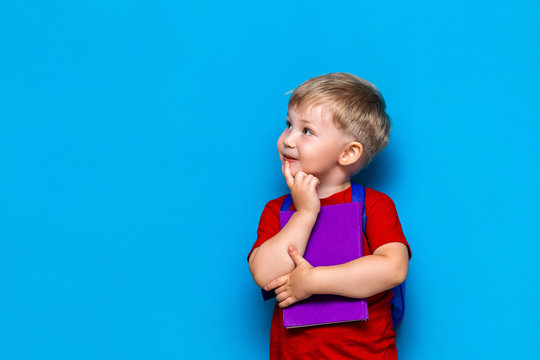 Back to school Portrait of happy surprised kid in glasses isolated on blue background with copy space. new school knowledges