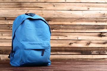 School backpack on brown wooden table