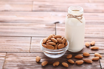 Almond milk in bottle on brown wooden table