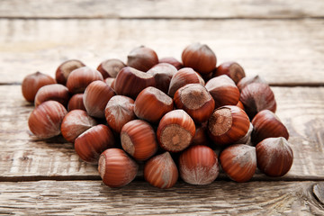 Ripe hazelnuts on brown wooden table