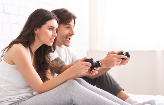 Concentrated man and woman competing in video game