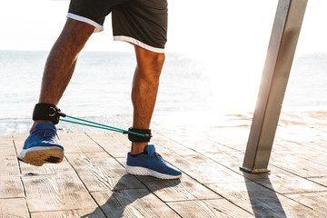 Confident afro american sportsman exercising with outdoors