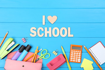Text I Love School with stationery on blue wooden table
