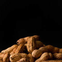 handful of peanuts on black background