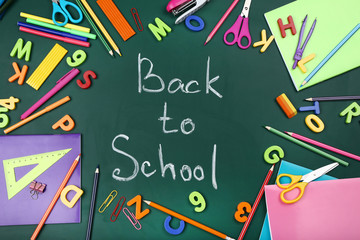 Text Back To School with stationery on green background