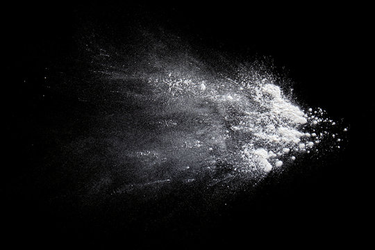 Color powder white splashes  dust on a black background.
