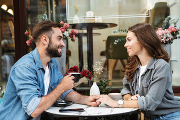 Attractive young couple in love having lunch