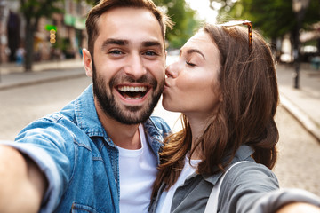 Beautiful young couple in love standing outdoors