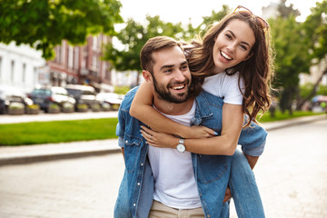 Beautiful young couple in love walking outdoors at the city street