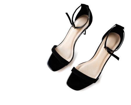 black high-heeled sandals on a white background. black suede open shoes close-up, isolate