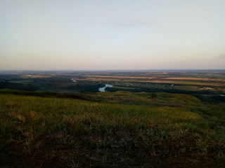 sunset over green field