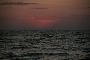 The setting sun going beyond the horizon of the Azov sea