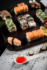 Sushi set with salmon, eel, tuna, avocado, cream cheese Philadelphia, caviar, chuka. Sushi menu. Japanese food on black and white background