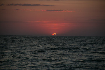 The setting sun going beyond the horizon of the Azov sea