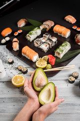 Sushi set with salmon, eel, tuna, avocado, cream cheese Philadelphia, caviar, chuka. Sushi menu. Japanese food on black and white background