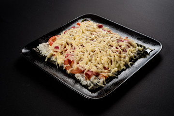 Sushi pizza on black