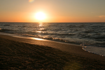 The setting sun going beyond the horizon of the Azov sea