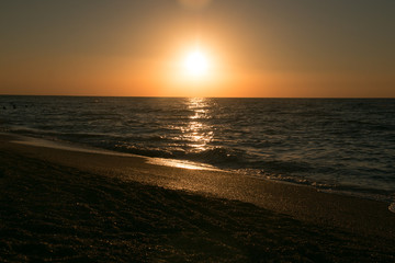 The setting sun going beyond the horizon of the Azov sea