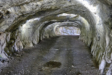 Naklejka premium Scenic view of cave near abandoned marble mine in Ruskeala national park in Karelia. Beautiful summer sunny look of grotte in popular touristic canyon on the North of Russian Federation