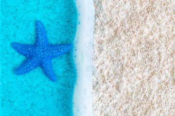 Fototapeta na wymiar Flat lay of blue starfish in sea near cost abstract.
