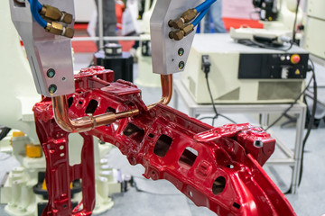 Fototapeta premium The robotic for spot welding the automotive frame parts. The hi-technology automobile assembly manufacturing process.
