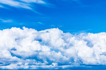 The vivid sky or heaven background with white and blue clouds under the sun rays