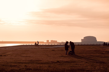 Beautiful sunset by the sea and the cruise terminal, Matosinhos, Portugal. People waiting to see the beautiful sunset on the beach of Matosinhos, Porto Portugal