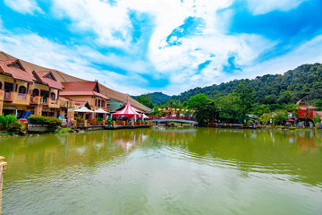 Fototapeta na wymiar View of beautiful oriental village in Langkawi surrounded by green mountains and lakes