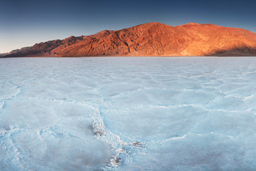 Obraz na płótnie Canvas View of the Basins salt flats, Badwater Basin, Death Valley, Inyo County, California, United States. Salt Badwater Formations in Death Valley National Park. Wonderful sunset. Bucket list for roadtrip.