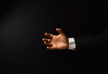 Businessman's hand on black background
