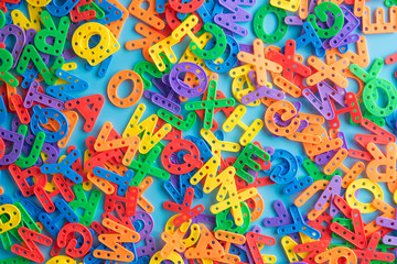 Colorful plastic alphabet letters on blue background,Top view.