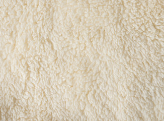 Soft fur yellow carpet,wool sheep fleece closeup texture background
