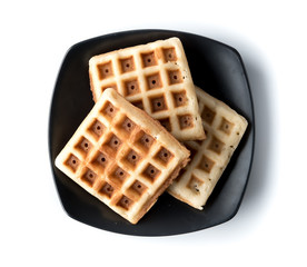Freshly baked waffles on plate isolated on white background,top view