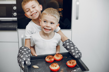 Child in a kitchen. Little brothers prepare the lunch