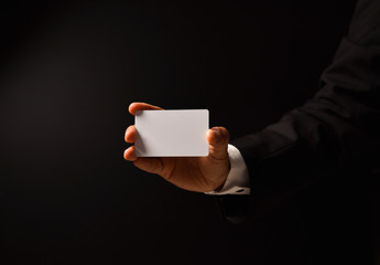 Businessman's hand on black background