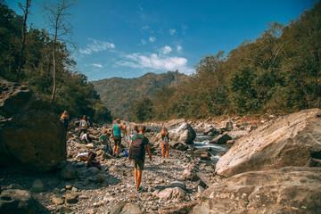 Tourists walking near the Ganga river during sunny day