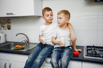Child in a kitchen. Little brothers prepare the lunch
