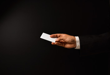 Businessman's hand on black background