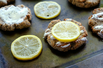 Fototapeta na wymiar Lemon poppy seed cookies with fresh lemon slices closeup, baking homemade dessert.