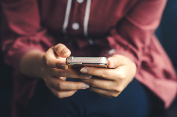 hipster woman using hands touching and typing on mobile phone screen search internet online working or social communication with digital technology app device in coffee shop indoor vintage lifestyle.