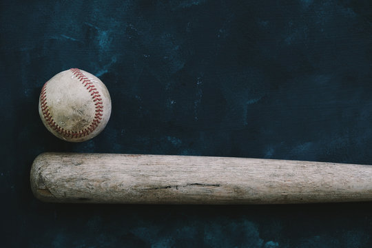 Baseball background with old wooden bat and ball, copy space for sports concept.