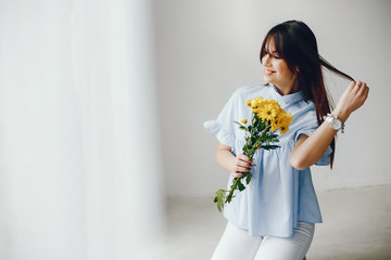 Cute girl with a flowers. Woman at home. Mother's day