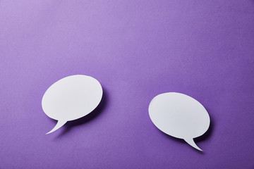 white speech bubbles cards on purple surface