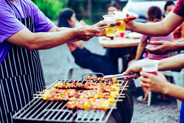 Enjoy the family party with barbecue grill with eat on the holidays. BBQ Party concept.