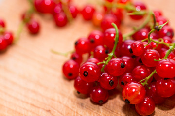 Delicious, home growth, organic red currants on wooden plate, shallow depth of field, copy space.