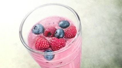 Glass of blueberry smoothie isolated on white background