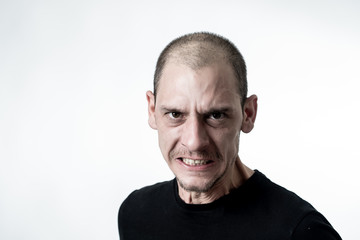 Mad and aggressive guy in facial expressions and negative human emotions