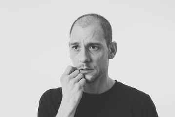 Facial expressions and human emotions. Portrait of confused young man thinking and looking puzzled