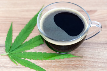 Black coffee with Cannabis(marijuana) leaves. Medical cannabis, Alternative medicine.