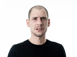 Obraz premium Facial expressions and human emotions. Portrait of confused young man thinking and looking puzzled